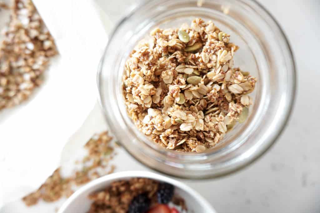 overhead shot of breakfast granola stored in a container, ready to serve