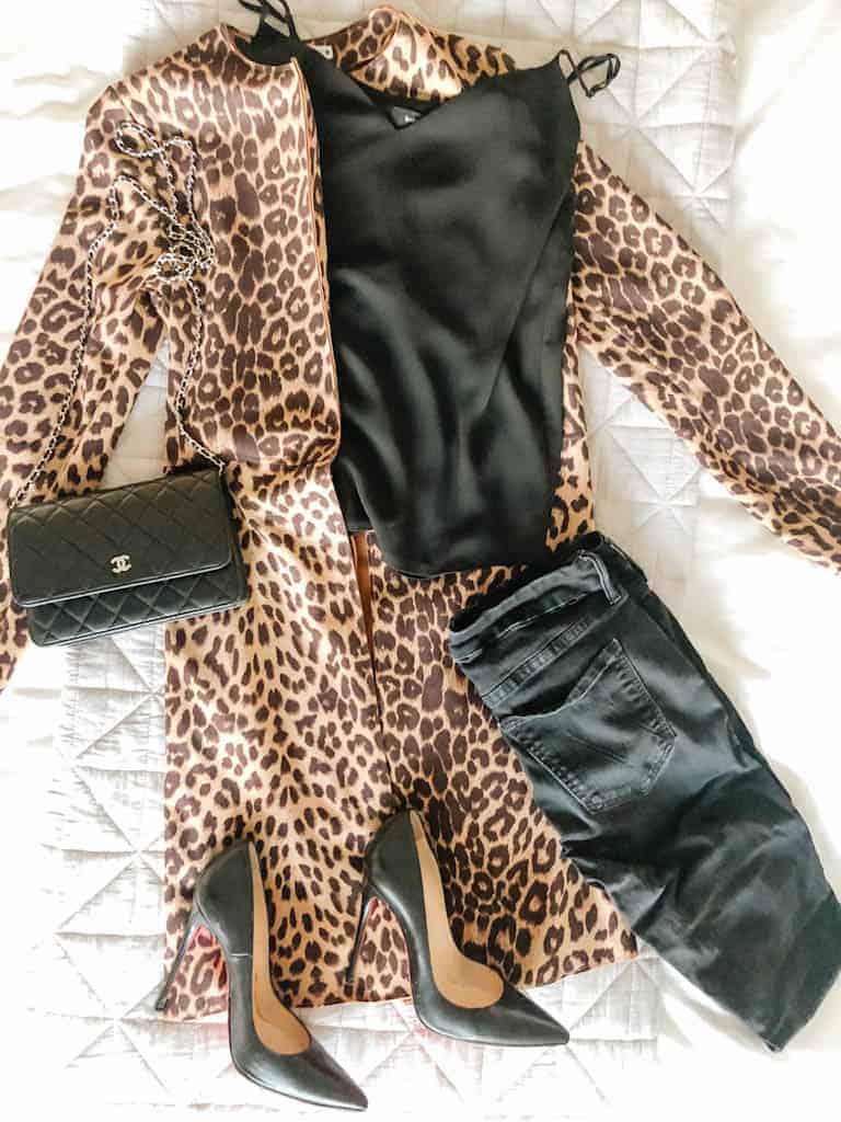 Signed Samantha's leopard moments - a flatlay of an outfit including a leopard jacket, black jeans, a black tank, black heels, and a black purse
