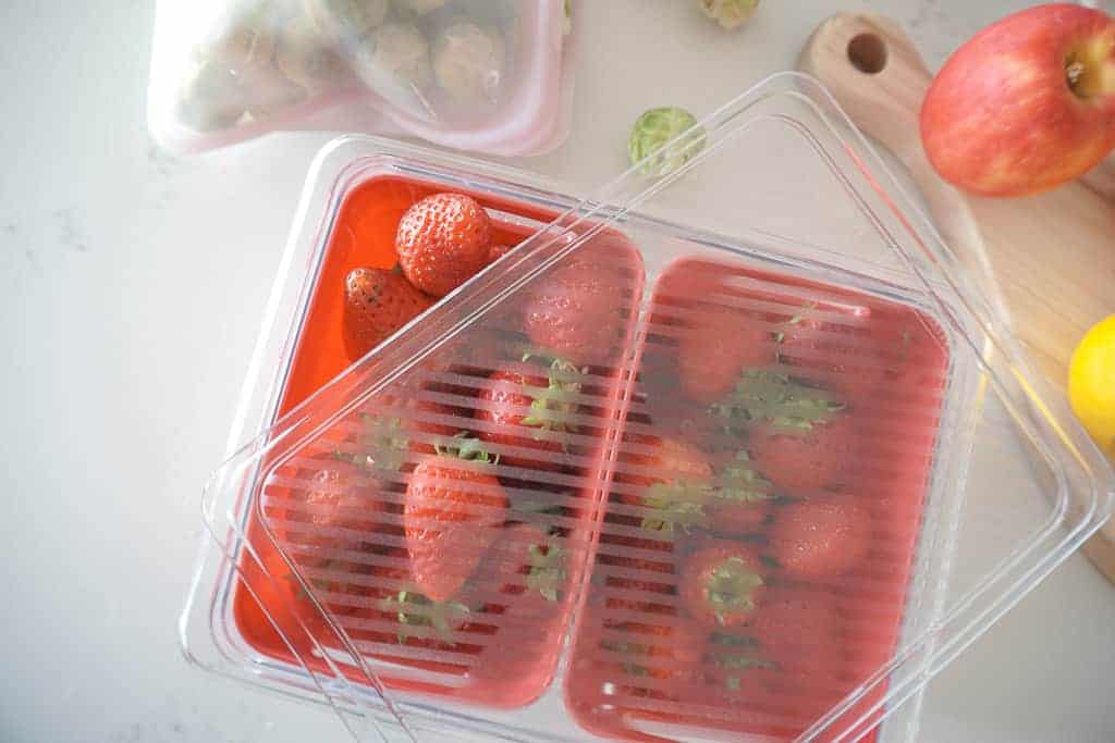 Signed Samantha's fridge organization strawberries in their berry baskets which has a lid and is stackable.