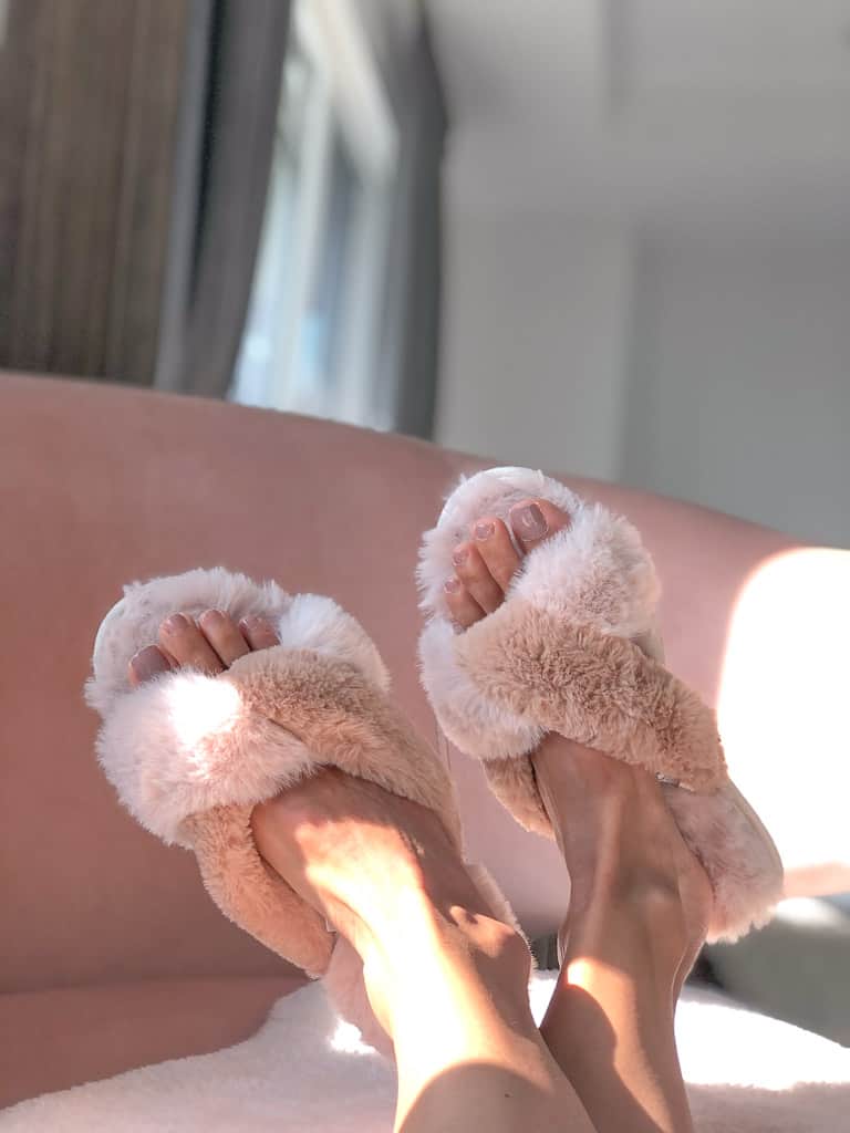 Signed Samantha's bedtime necessities include these slippers pictured - they technically are not for bedtime but you get the idea - they are sandal-like, with two tones of fuzzy pink fabric.