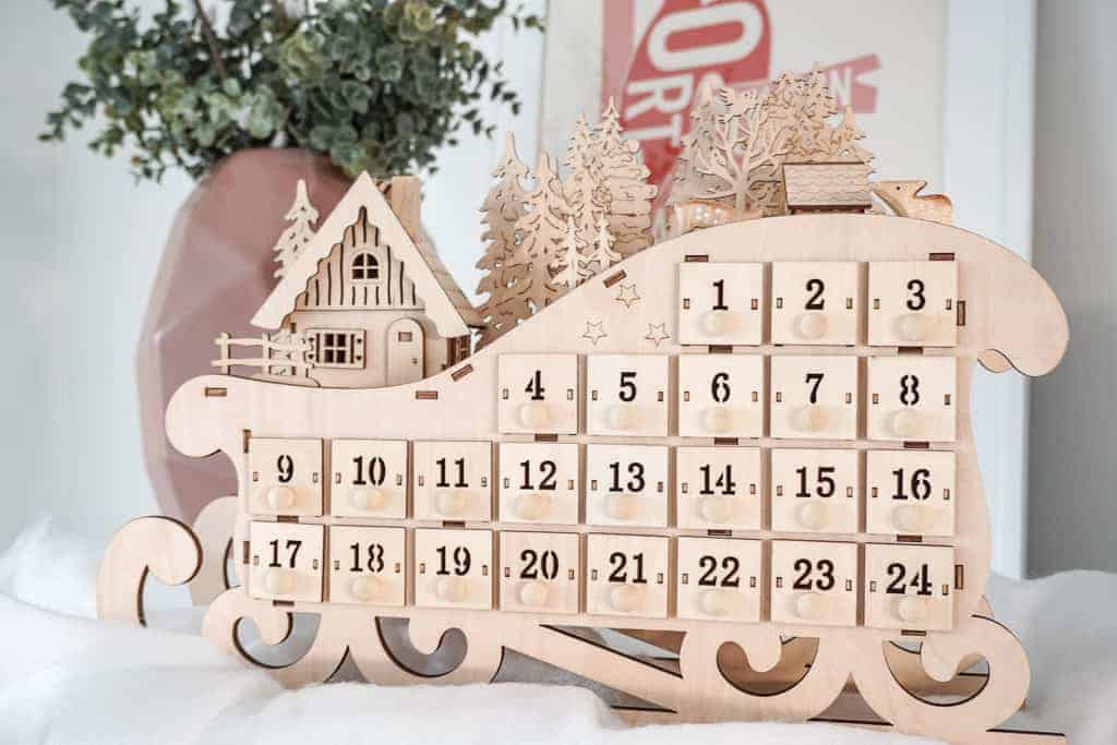 Signed Samantha's 2020 Holiday Decor includes a lot of wood tones, including a wooden sleigh which is also an advent calendar.