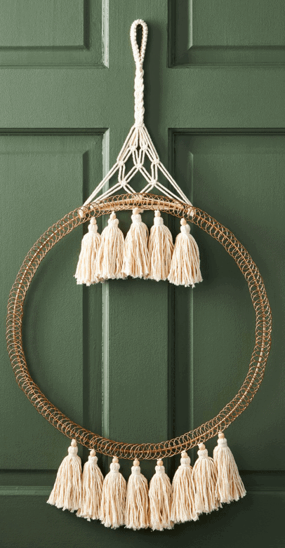 Inspiration for Signed Samantha's D.I.Y Christmas Card Holder is this greeting card holder from Anthropologie - it is a circular shape, with macrame tassels coming from the bottom/