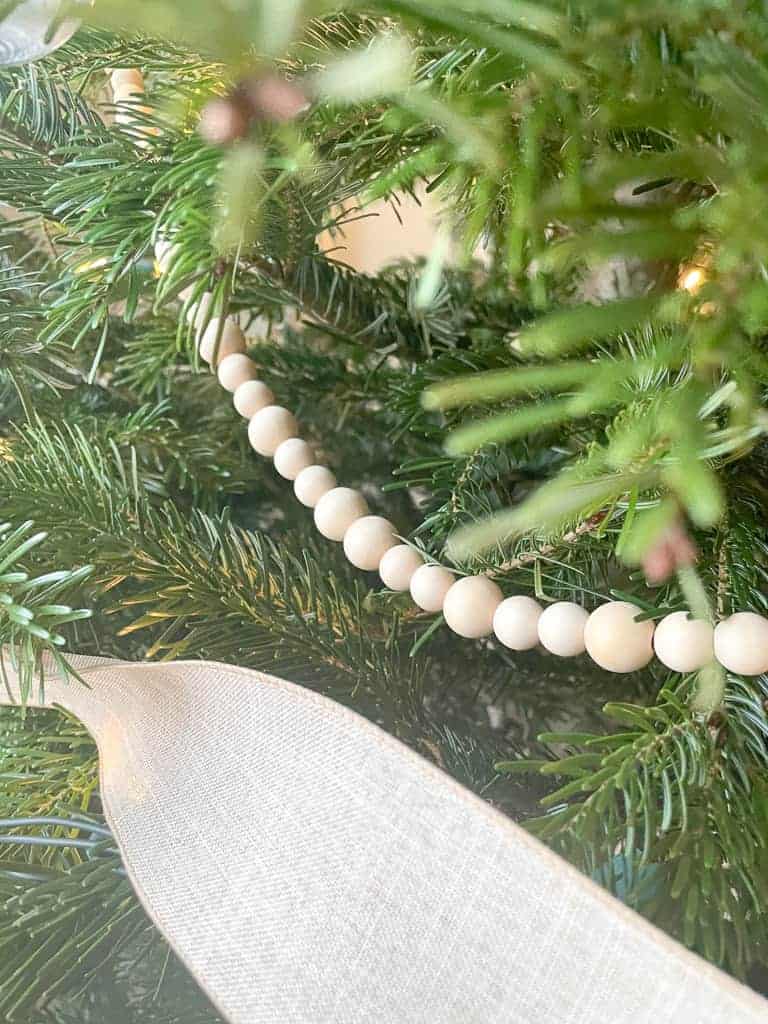 A close up of D.I.Y wood bead garland on Signed Samantha's Christmas Tree.