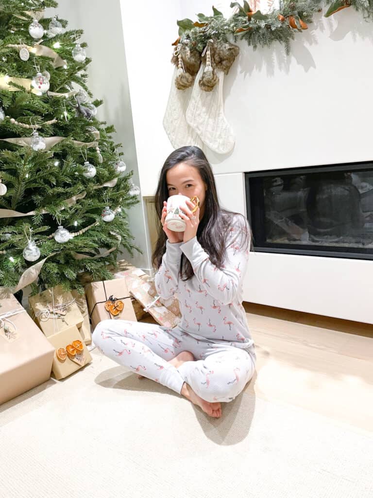 Signed Samantha is sharing two truths and a lie she is sitting in front of her fireplace and Christmas tree drinking from her tea