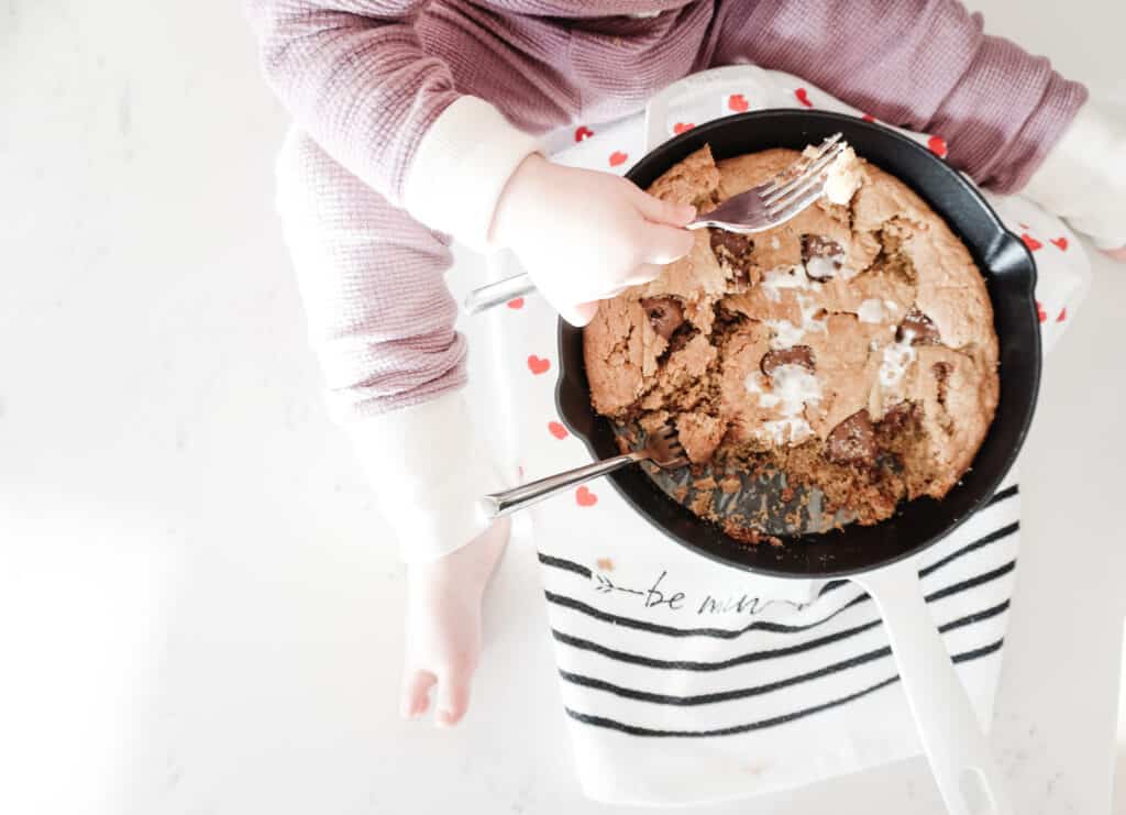 Signed Samantha's daughter, Sloane eating a gluten-free chocolate chip skillet cookie straight from the skillet.