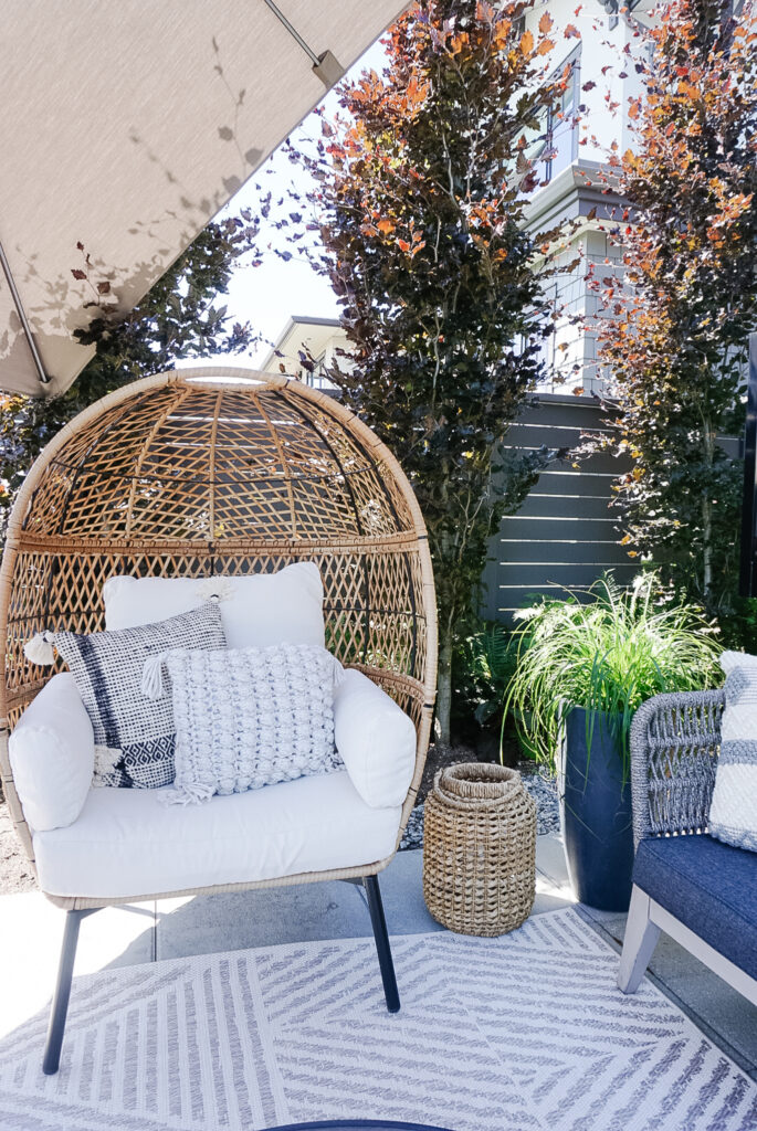 signed samantha's vancouver patio space with planters, pillows, and lanterns to warm up the space