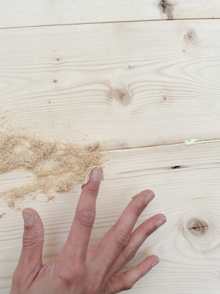 How to make your DIY rustic desk top with pocket screws - two 1x8s pictured together with wood glue and saw dust