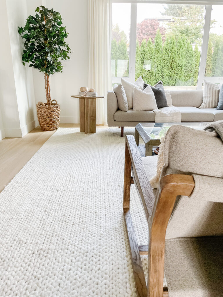 off white veronica woll braided area rug in signed samantha's living room - she is giving a full review of rugs usa's rugs