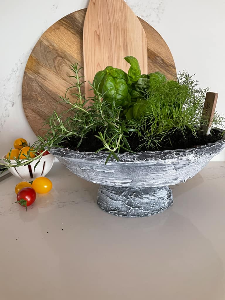 A herb garden made out of a DIY pedestal bowl.