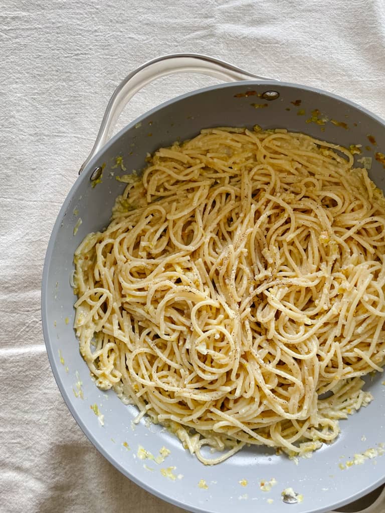 lemon cacio e pepe spaghetti pictured in a sauce pan