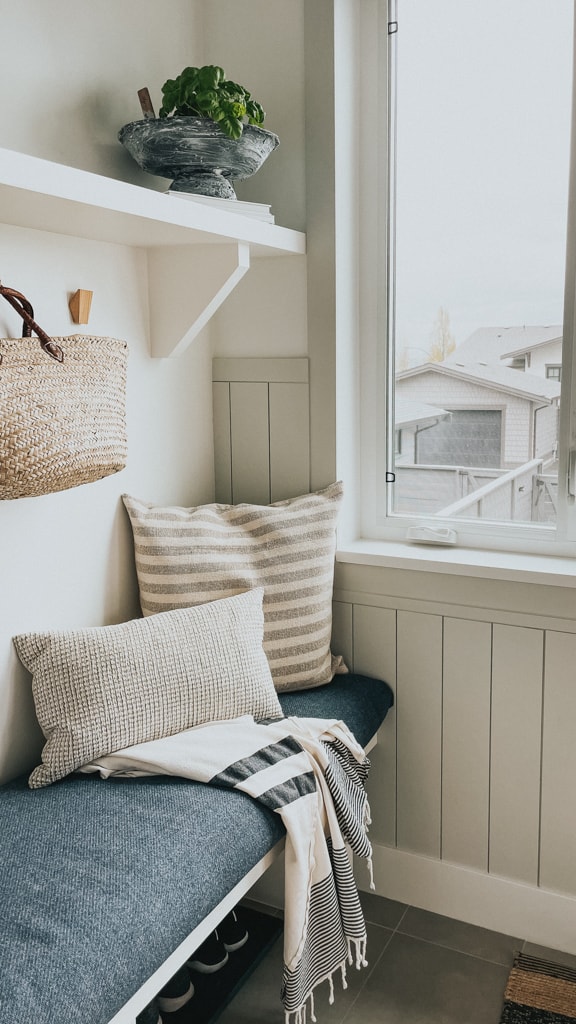 a mudroom bench with pillows and home decor items from canadian stores