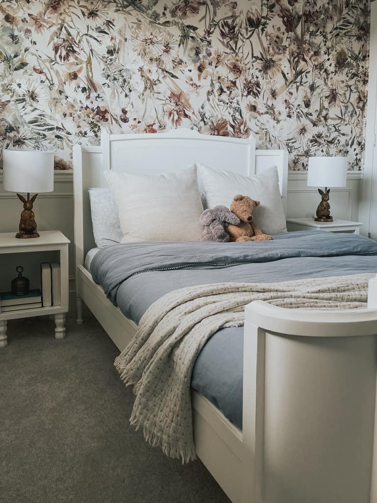 a sweet bedroom with white furniture and floral wallpaper and a bunny lamp from a canadian home decor store