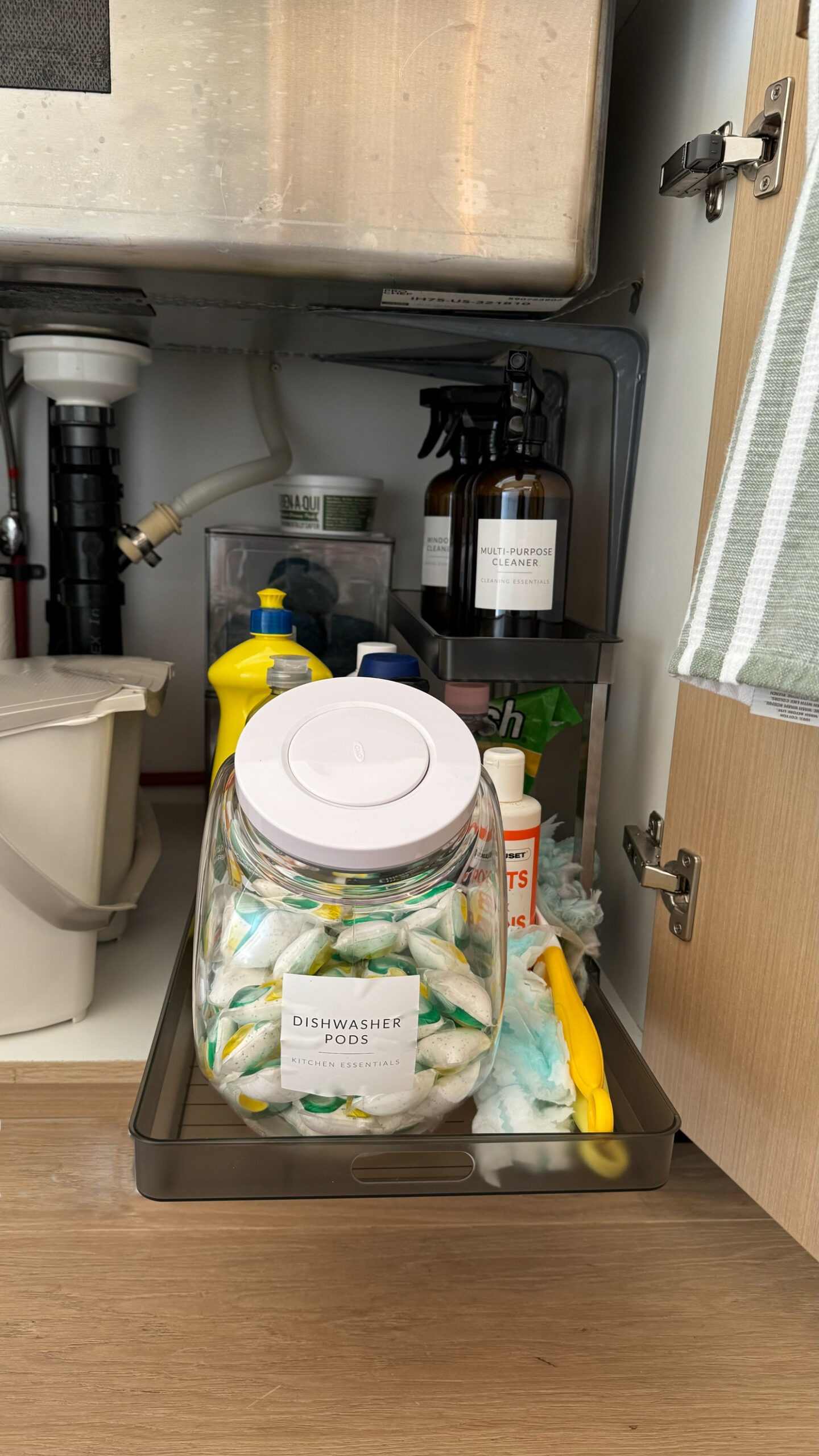 organizing under the kitchen sink with a pull out organizer